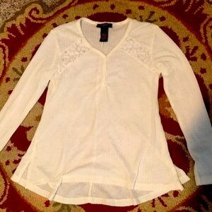 Sheer white shirt with lace flower detailing on the chest and cute buttons